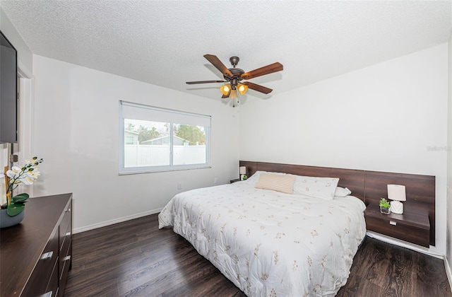 bedroom featuring dark hardwood / wood-style flooring, a textured ceiling, and ceiling fan