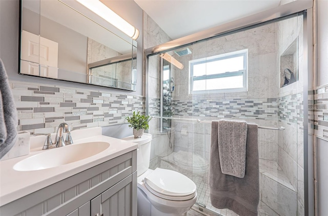 bathroom featuring vanity, toilet, and a shower with door