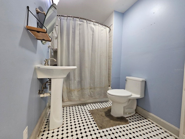 bathroom featuring shower / bath combination with curtain and toilet