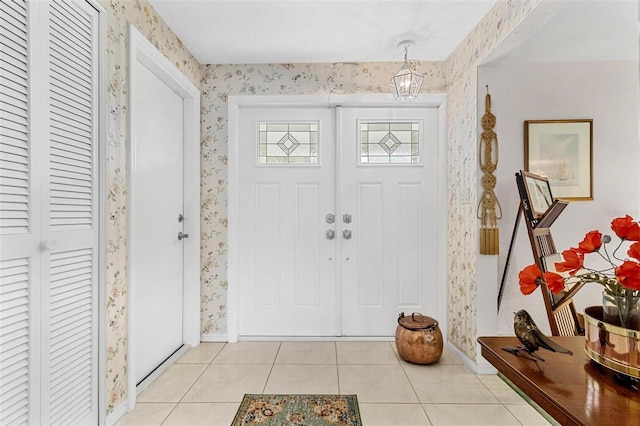 foyer entrance with light tile patterned flooring