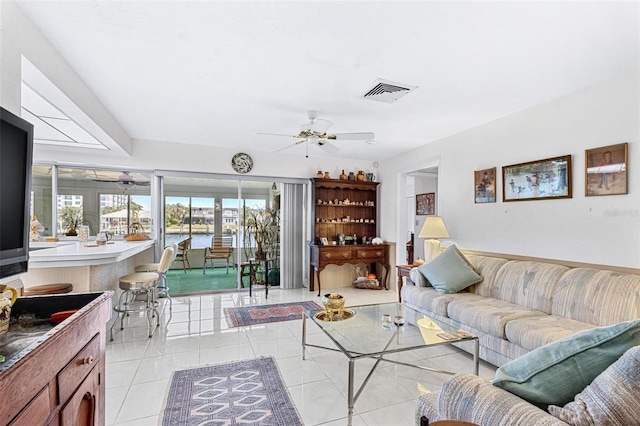 living room featuring light tile patterned floors and ceiling fan