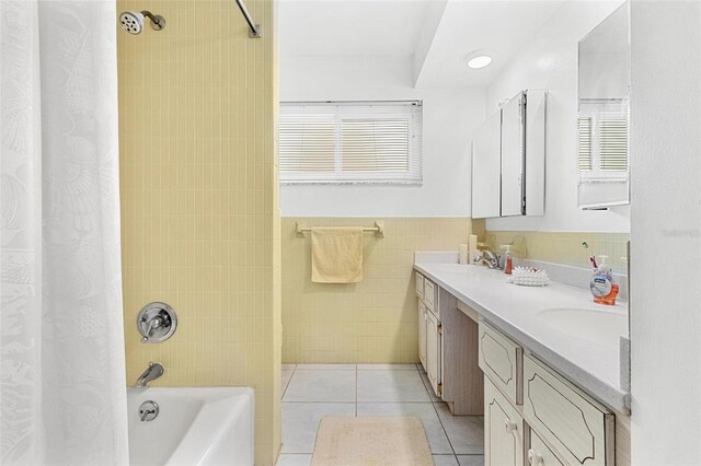 bathroom with tile walls, vanity, tile patterned flooring, and shower / bath combo with shower curtain