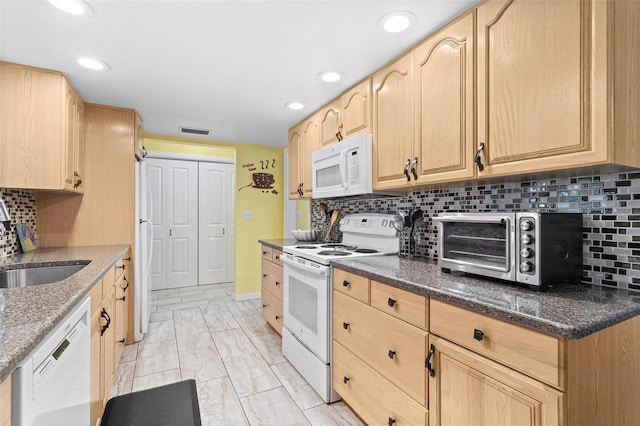 kitchen with tasteful backsplash, white appliances, light brown cabinetry, and sink