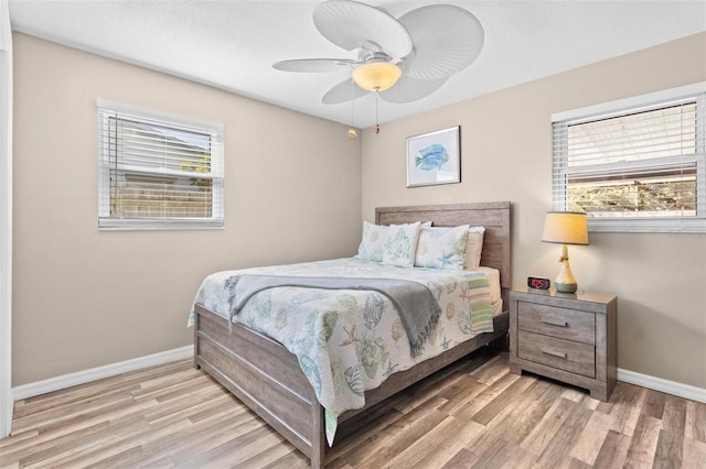 bedroom with light hardwood / wood-style floors and ceiling fan