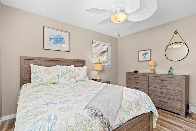 bedroom with light wood-type flooring and ceiling fan