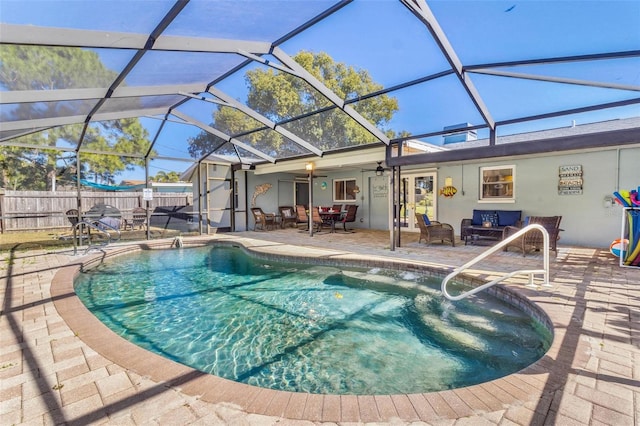 view of swimming pool featuring ceiling fan, glass enclosure, and a patio area