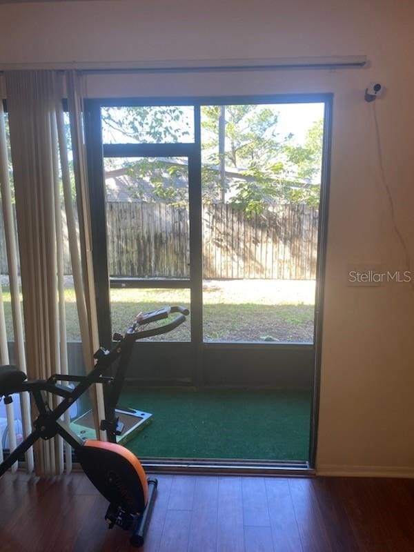 doorway with hardwood / wood-style flooring