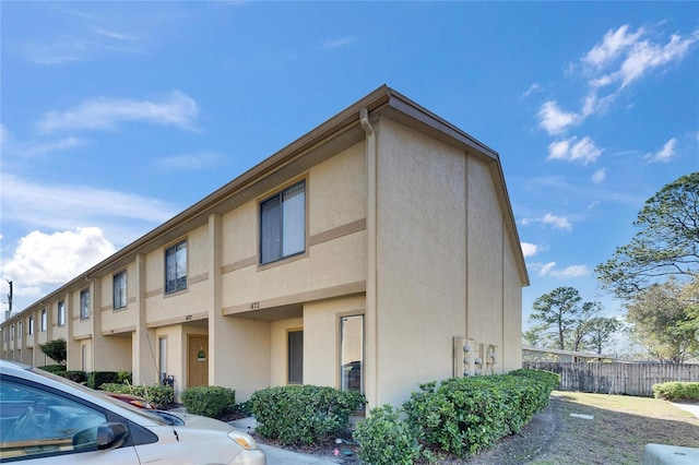 exterior space with fence and stucco siding