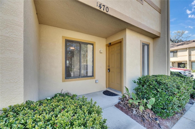 entrance to property with stucco siding