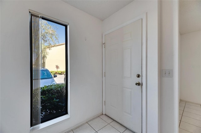 doorway to outside featuring light tile patterned floors