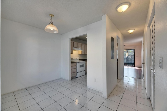 interior space featuring a textured ceiling and light tile patterned flooring