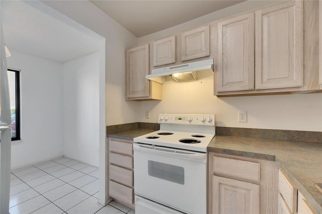 kitchen featuring light tile patterned flooring, light brown cabinets, under cabinet range hood, electric stove, and dark countertops