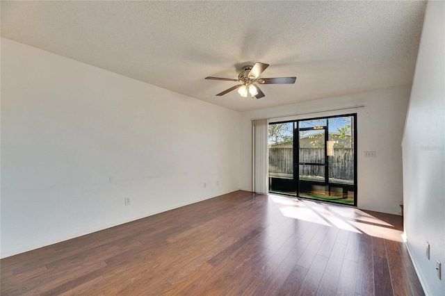 empty room with a textured ceiling, a ceiling fan, and wood finished floors