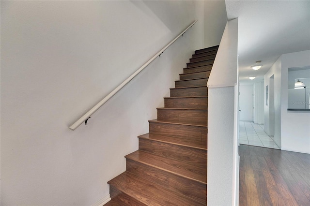 stairway featuring wood finished floors