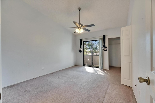 unfurnished room featuring light carpet, vaulted ceiling, and a ceiling fan