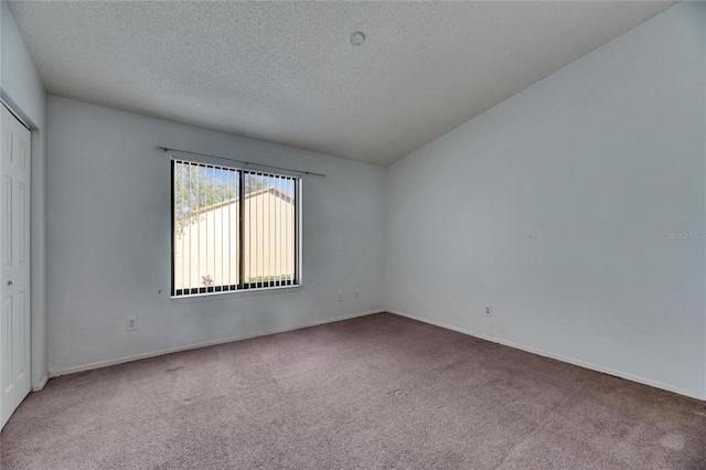 interior space featuring a textured ceiling and baseboards