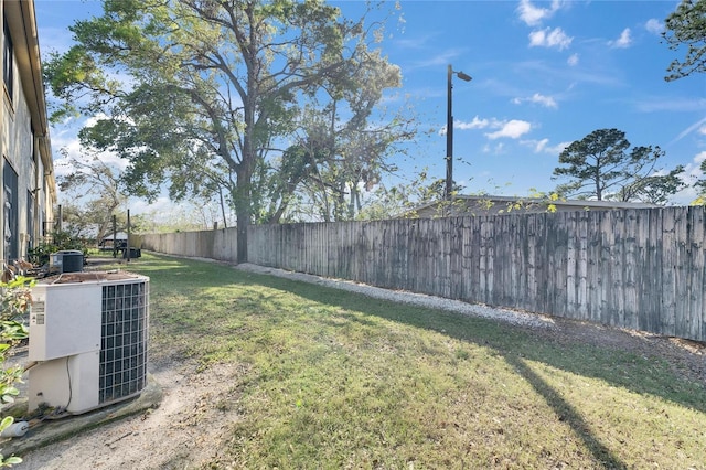 view of yard featuring a fenced backyard and central AC unit