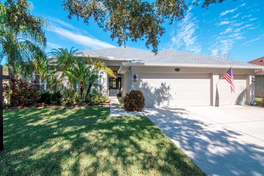 single story home with a garage and a front yard