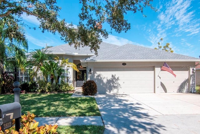 ranch-style house with a garage and a front lawn