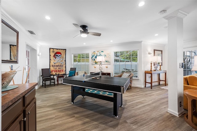 game room with crown molding, hardwood / wood-style floors, decorative columns, and ceiling fan