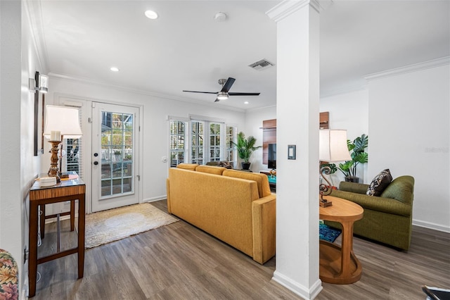 living room with wood-type flooring, crown molding, ceiling fan, and ornate columns