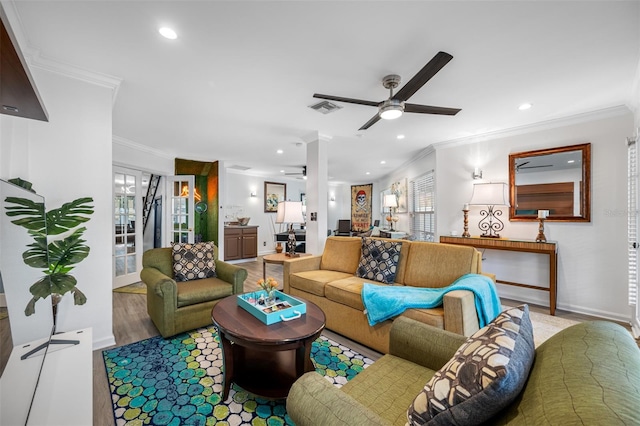 living room featuring ceiling fan, ornamental molding, plenty of natural light, and hardwood / wood-style floors