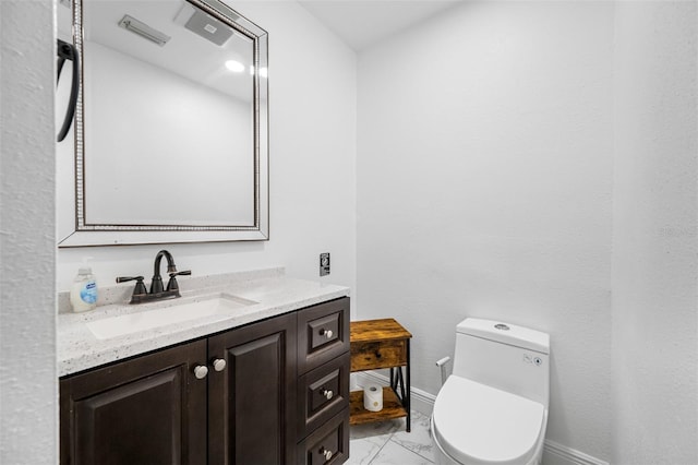 bathroom with toilet and vanity