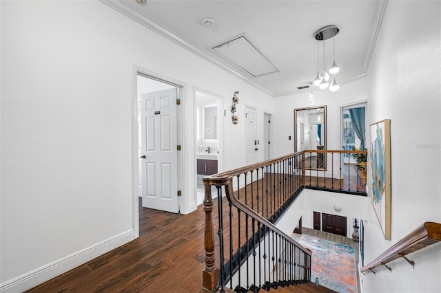 staircase with wood-type flooring and crown molding