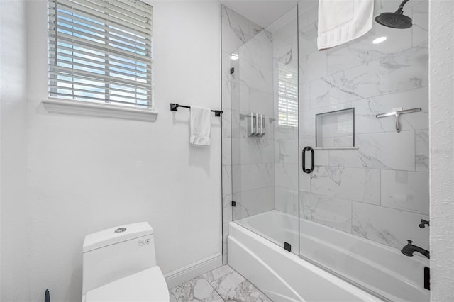 bathroom featuring bath / shower combo with glass door and toilet