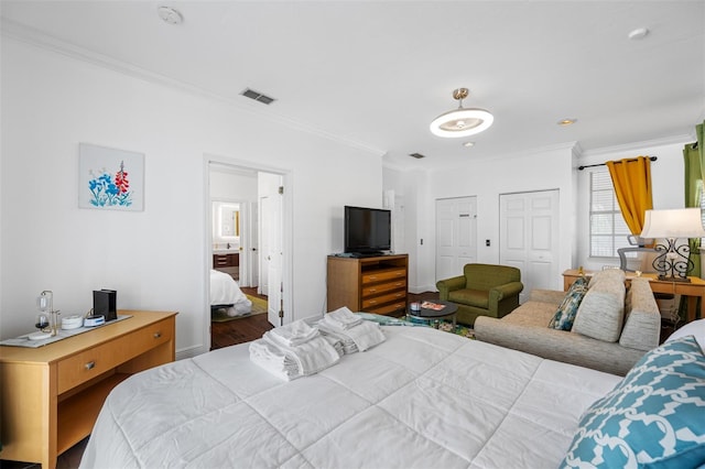 bedroom with hardwood / wood-style floors and ornamental molding