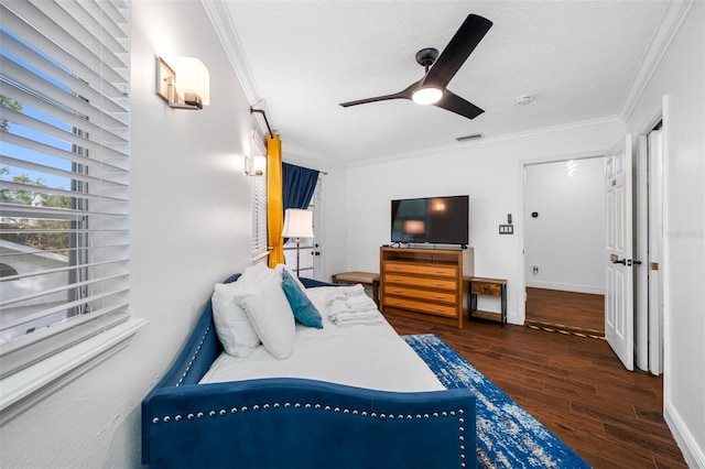 bedroom featuring dark hardwood / wood-style flooring, ceiling fan, and ornamental molding