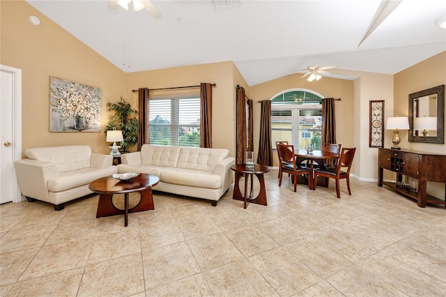 living room featuring ceiling fan, vaulted ceiling, and light tile patterned floors