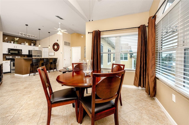 tiled dining room with vaulted ceiling and ceiling fan