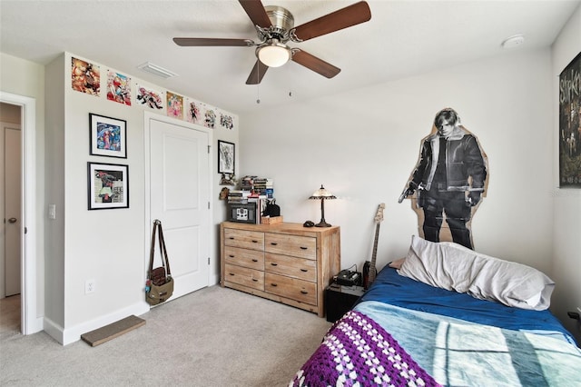 bedroom featuring light colored carpet and ceiling fan