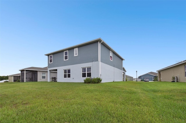 back of house featuring a yard