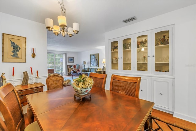 dining room with an inviting chandelier and light hardwood / wood-style floors