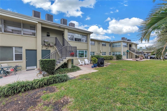 view of community with a lawn and a patio