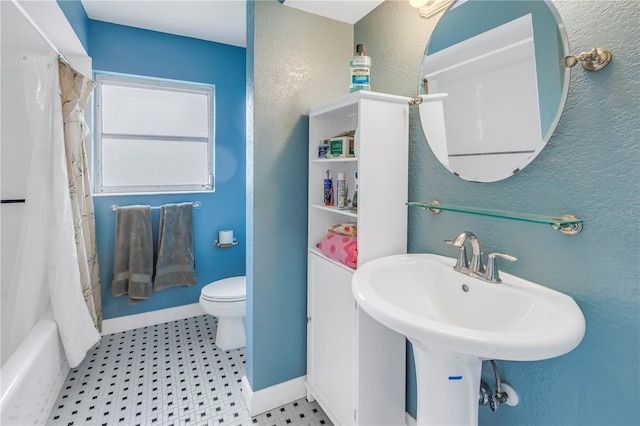 full bathroom with sink, shower / bath combination with curtain, and toilet