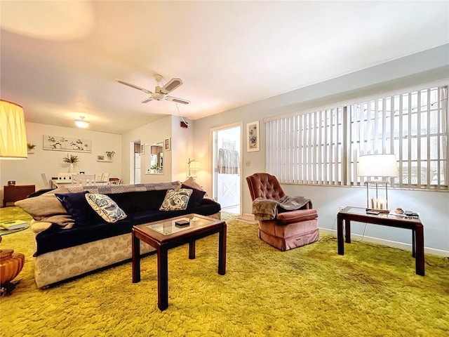 carpeted living room with ceiling fan