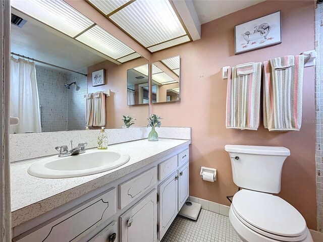 bathroom featuring a shower with curtain, vanity, toilet, and tile patterned flooring