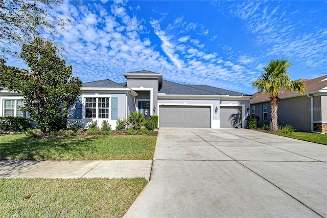 view of front of house with a garage and a front yard