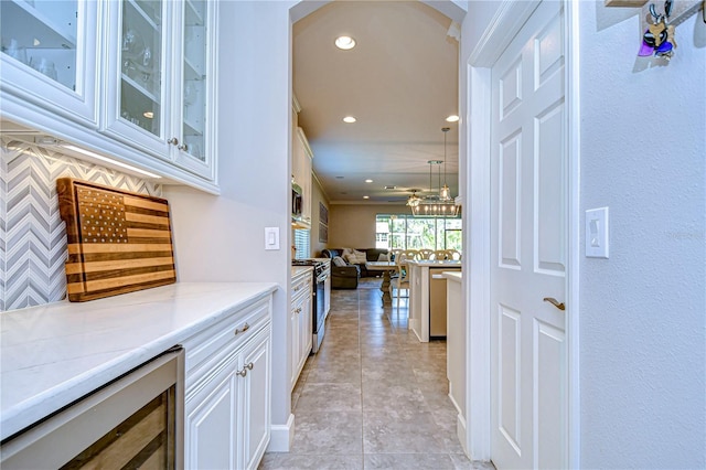 hall featuring light tile patterned flooring and wine cooler