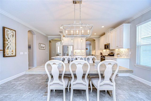 dining space with crown molding