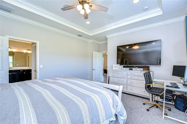 bedroom with ceiling fan, ornamental molding, a tray ceiling, and carpet flooring