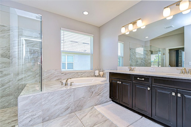 bathroom featuring vanity and independent shower and bath