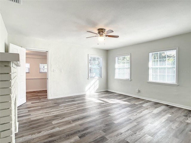 spare room with wood-type flooring and ceiling fan