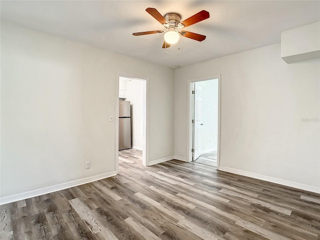 unfurnished room featuring ceiling fan and dark hardwood / wood-style floors