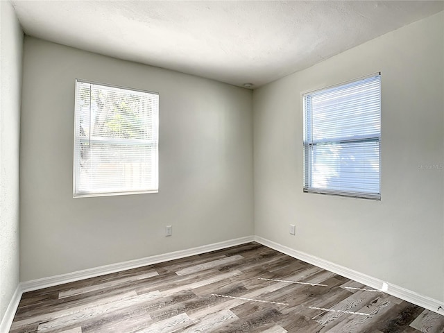 unfurnished room featuring hardwood / wood-style floors