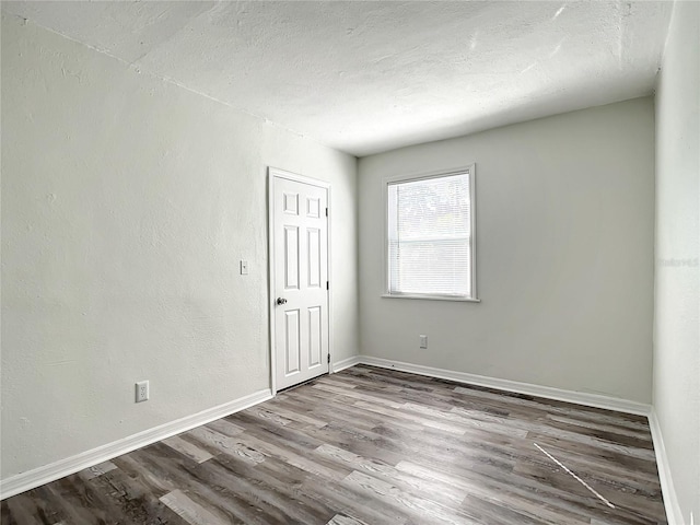 empty room with wood-type flooring