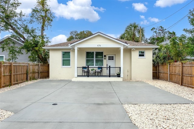 rear view of property featuring a porch